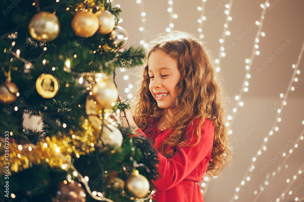 Young Girl Decorating Christmas Tree Young Girl Decorating Christmas Tree