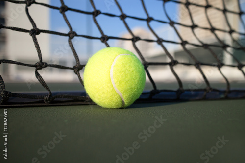 Tennis ball on hard court © icedmocha
