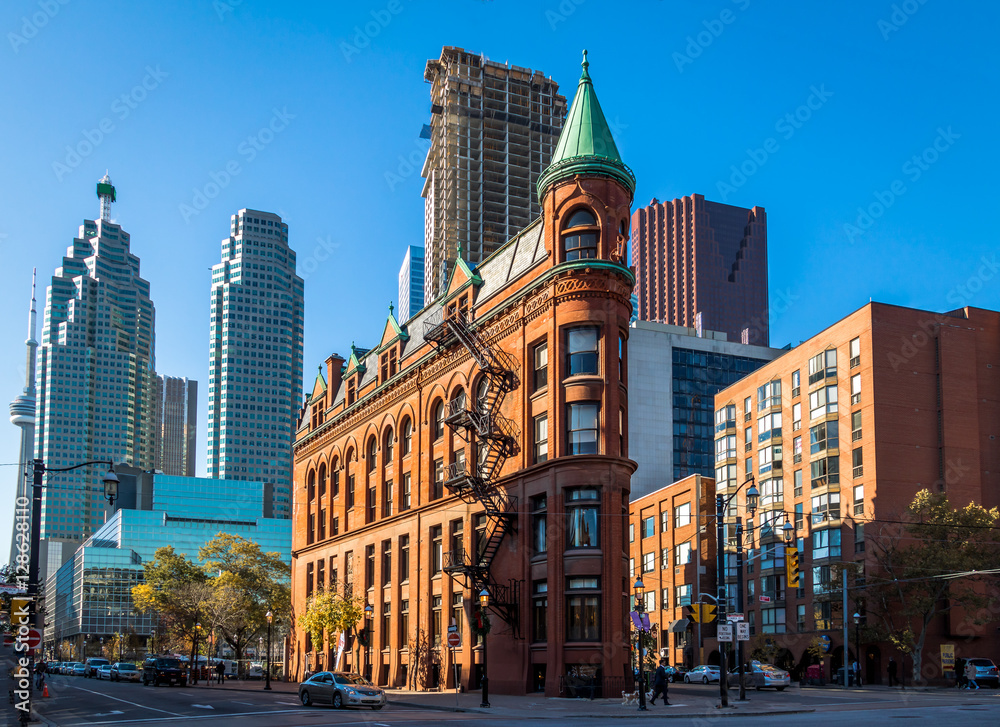 Gooderham or Flatiron Building in downtown Toronto with CN Tower on backgound - Toronto, Ontario, Canada