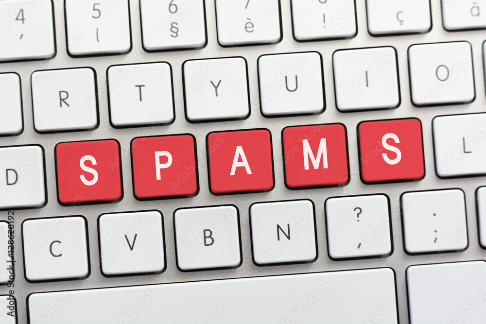 SPAMS writing on white keyboard SPAMS writing on white keyboard