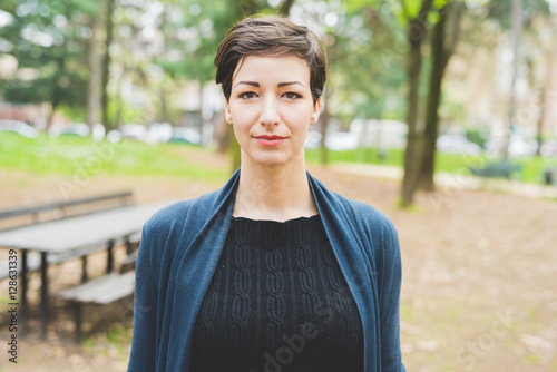 Photography portrait of young beautiful caucasian brown hair woman posing outdoor in the cit