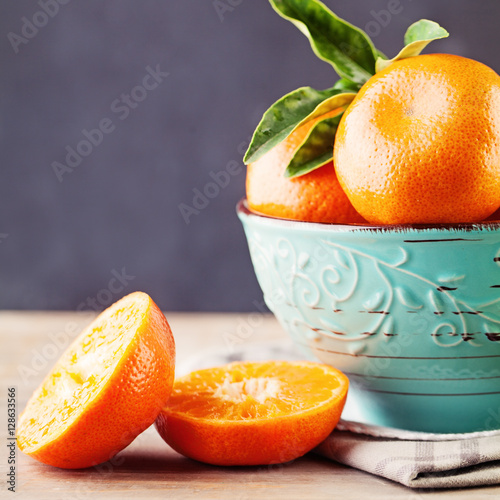 Juicy Mandarin Fruit in a Bowl on Background