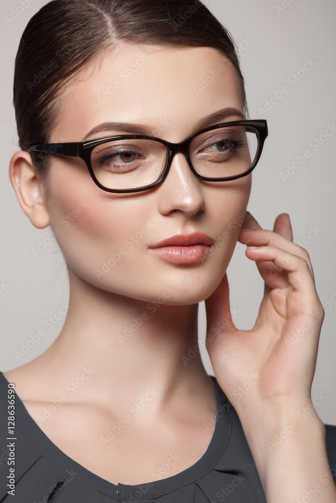 Close-up portrait of beautiful young woman in stylish glasses