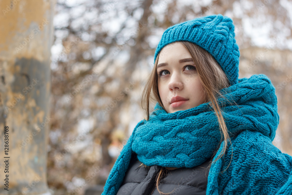 Beautiful girl on the nature in the winter outside in winter hat