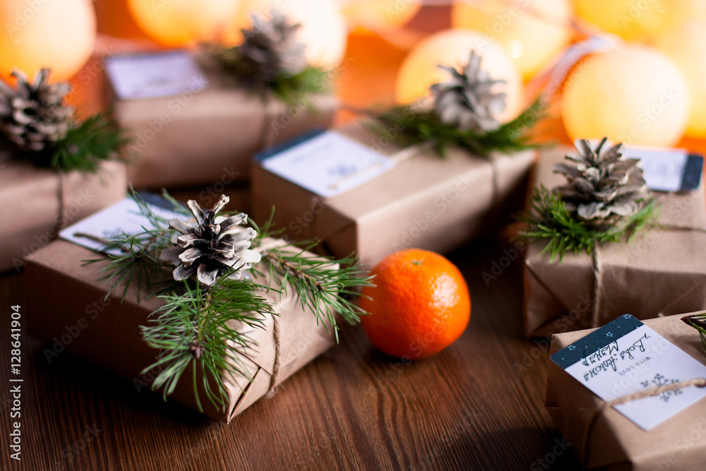 Decorated gift boxes and garland on the wooden background