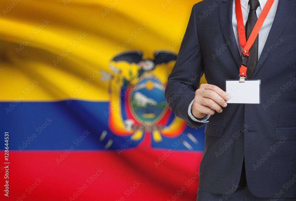 Businessman holding name card badge on a lanyard with a national flag on background - Ecuador Businessman holding name card badge on a lanyard with a national flag on background - Ecuador