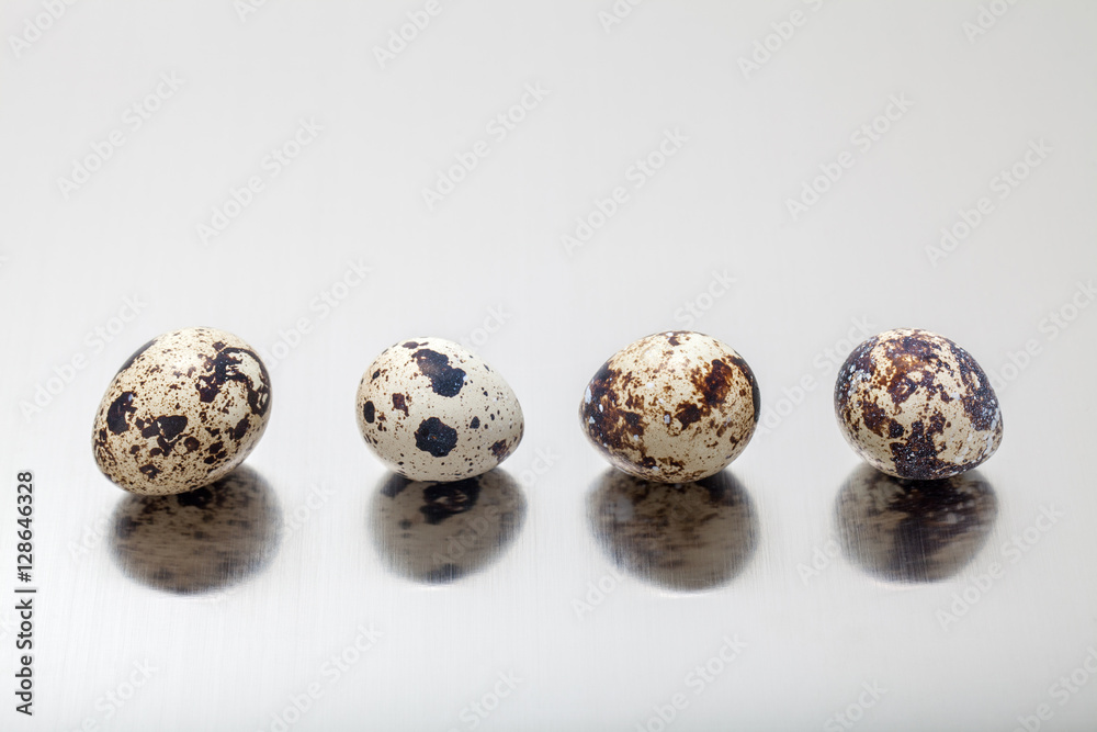 Quail eggs on gray background.