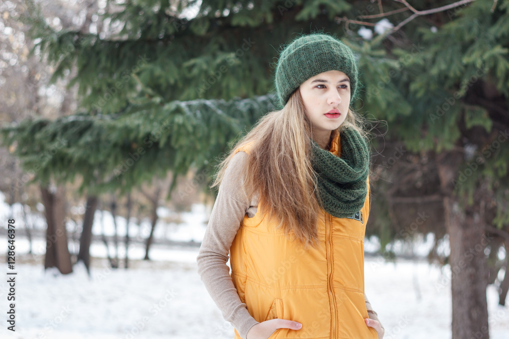 Beautiful girl on the nature in the winter outside in winter hat