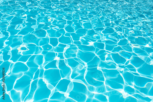 Beautiful ripple water surface with sun reflection in swimming pool