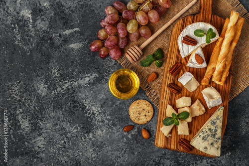 Assortment of cheese with wine, honey, nuts and grape