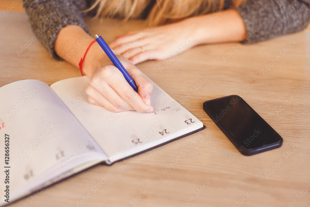 Close up of a woman hand writing letter to home Close up of a woman hand writing letter to home