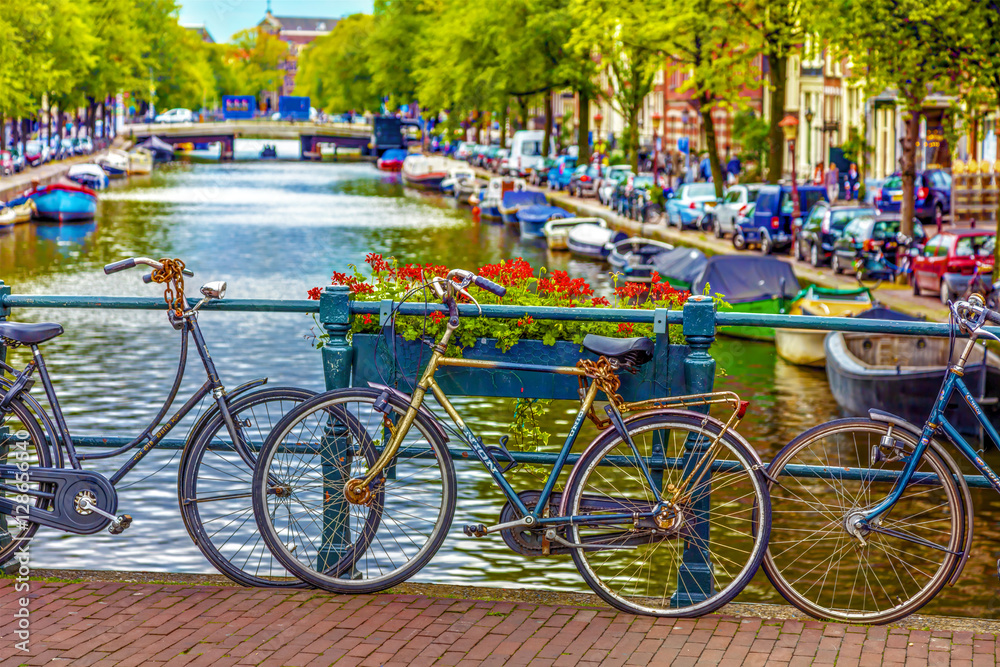 Amsterdam, The Netherlands - August 26. 2011.: Bicycles and flowers on a small bridge over the canal in Amsterdam.
Flowers blossom and bicycles on a small bridge in Amsterdam, HDR Image.