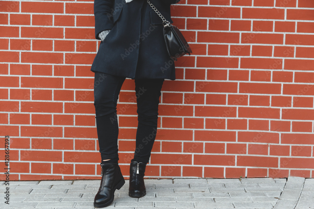 Young beautiful woman in autumn coat with stylish bag, shoes, striped blouse on the street Young beautiful woman in autumn coat with stylish bag, shoes, striped blouse on the street