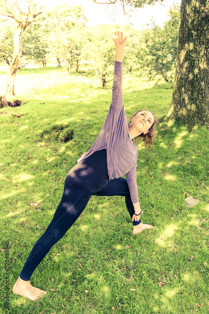 young fit woman pose streching on grass in park young fit woman pose streching on grass in park