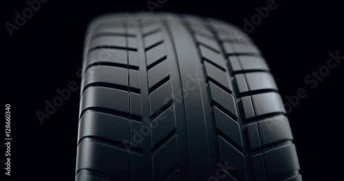 Close up on a car tire in motion, with deph of field effect. Seamless looping animation, 4k animation.