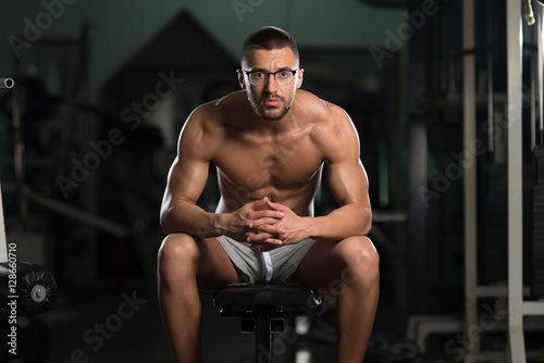 Attractive Young Geek Resting In Gym Afther Exercise