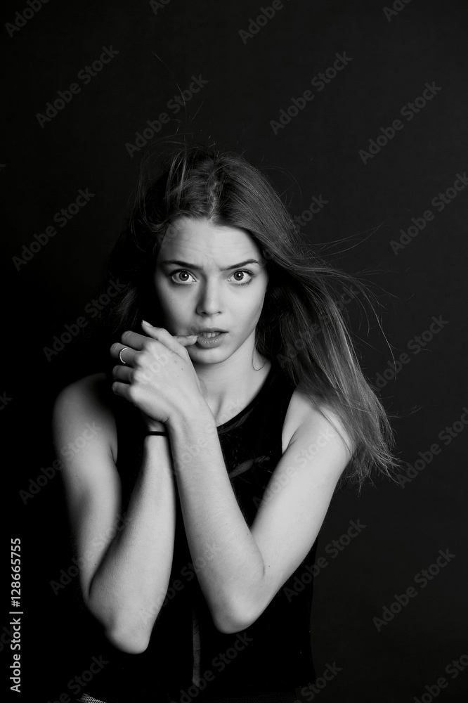 A young girl with long hair. Sensual finger around the lips . BW A young girl with long hair. Sensual finger around the lips . BW
