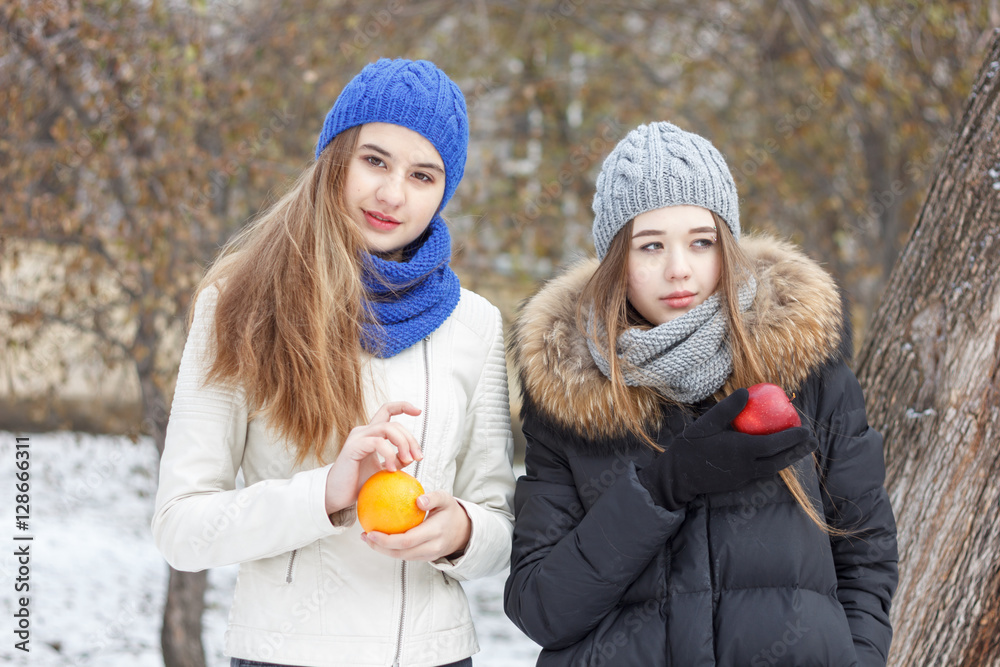 Fototapeta premium Beautiful girl on the nature in the winter outside in winter hat
