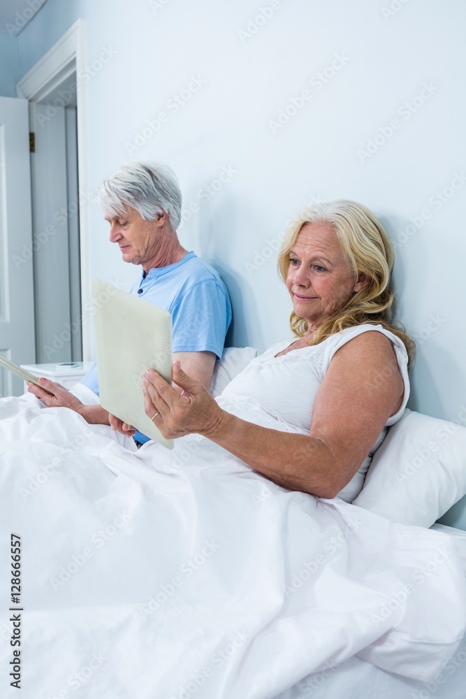 Retired couple using tablets Retired couple using tablets