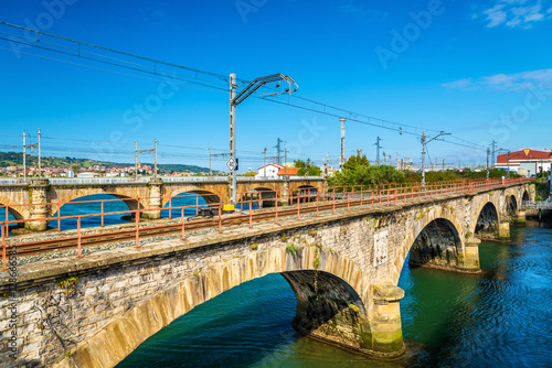 Railway bridges over the Bidasoa river on the France - Spain border photo
