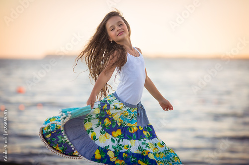 Adorable happy smiling little girl on beach vacation