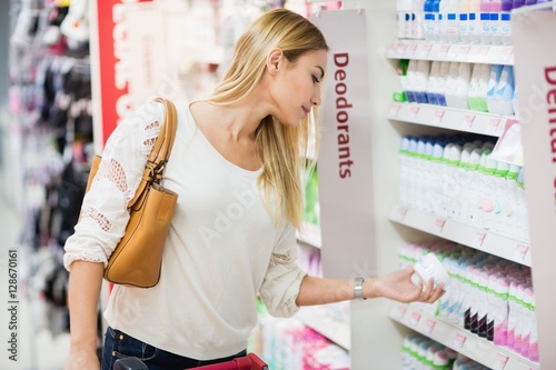 Side view of woman choosing deodorant