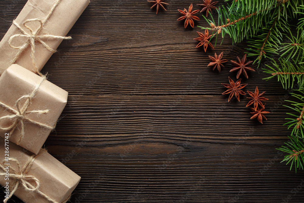 Christmas composition on wooden background with tree, pine cones, star anise and cardboard boxes Christmas composition on wooden background with tree, pine cones, star anise and cardboard boxes