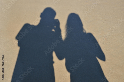 фотографія Two shadows on the wet sandy surface