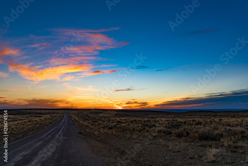 Sunset over a rural dirt road © tristanbnz