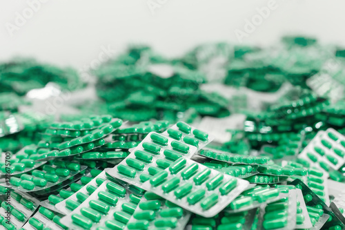 Fotografi pills in packs rolled in pile