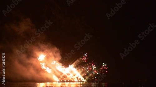 Fireworks Like an Ordnance Exploding on the Boat Explosion on the Oilship Pyrotechnics Show Flashes of Light Clouds of Smoke Victory Day Celebration photo