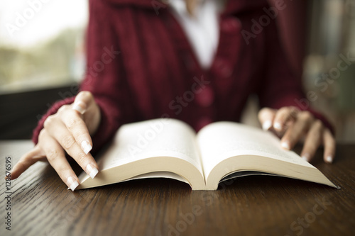 Woman Reading Book At Cafe