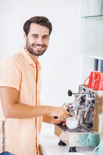 Obraz na plátne Man preparing coffee from coffeemaker