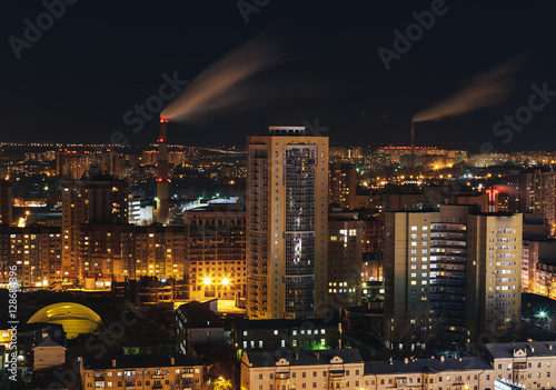 Fantastic view of a big city by night with illuminated modern architecture. Voro photo