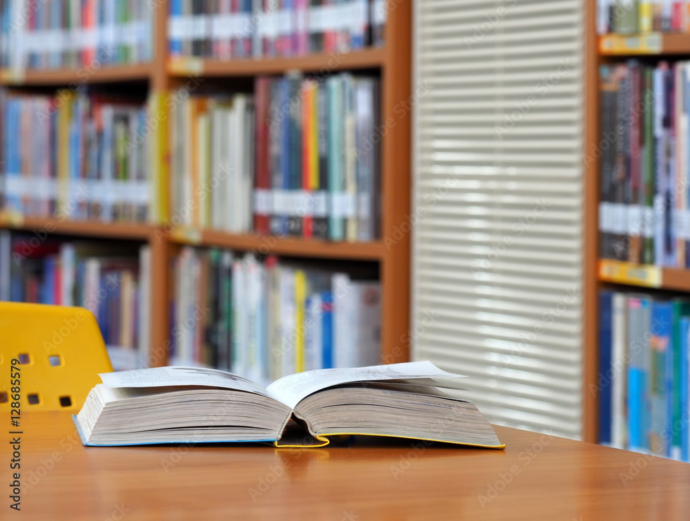 Book open page on wood desk in the library room, education concept Book open page on wood desk in the library room, education concept