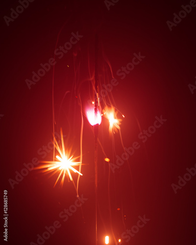 Christmas sparkler in haze with red light