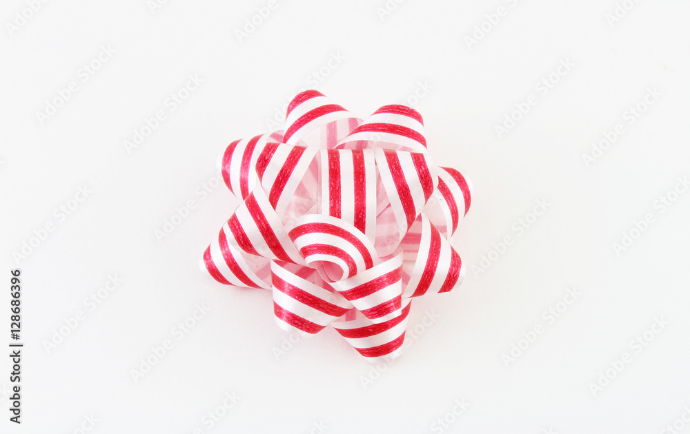 Red and white striped holiday bow isolated on white