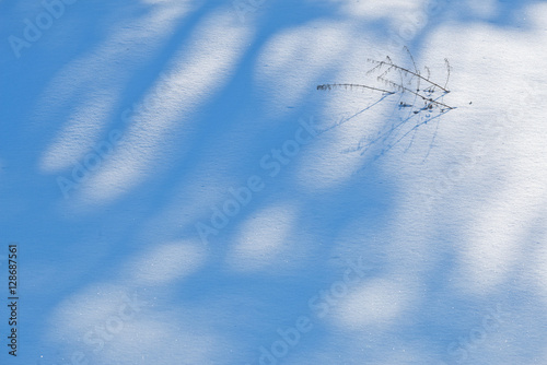 Shadows in snowdrift on bright sunny day Christmas background.