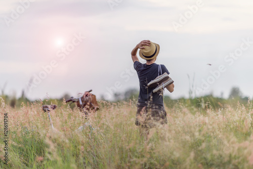 Girl is in the field of meadow looking for picnic area