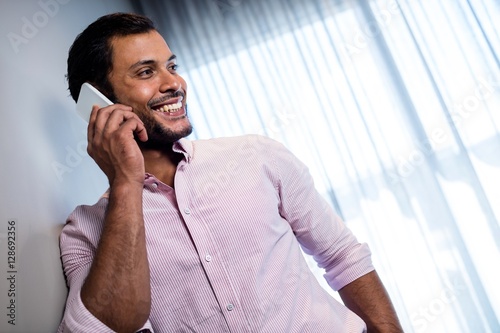 Happy businessman calling with smartphone