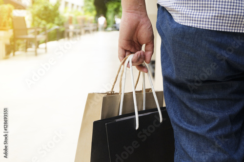 Concept of man shopping and holding bags, closeup images.