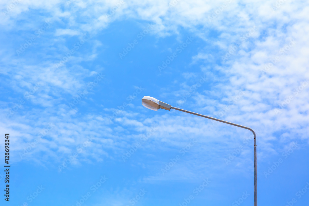 street lamp post with blue sky and cloud.