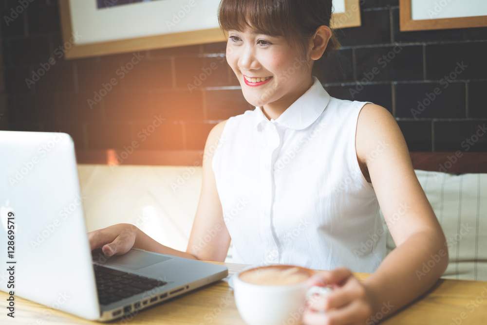 Businesswoman Working On Laptop In Coffee Shop. Young business w Businesswoman Working On Laptop In Coffee Shop. Young business w