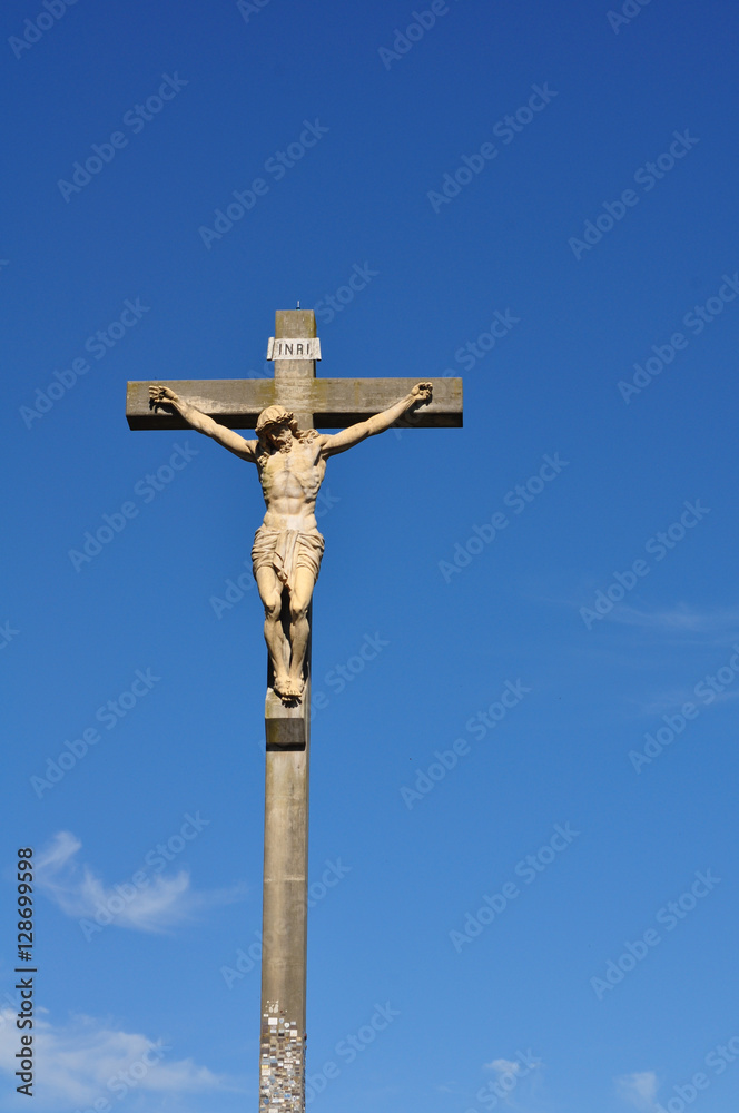 View of the a Jesus Statue in the Calvario of Tandil City in Buenos Aires, Argentina against blue sky.