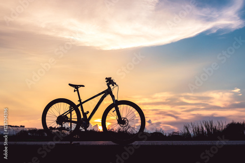 Silhouette mountain bicycle at beautiful sunset sky