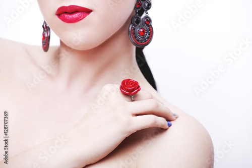 Beautiful woman face with red lips. Jewelry and Beauty