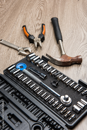 The repair tools is placed on the wooden table.