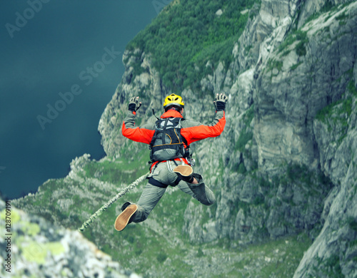 A man jumps from a cliff into the abyss.