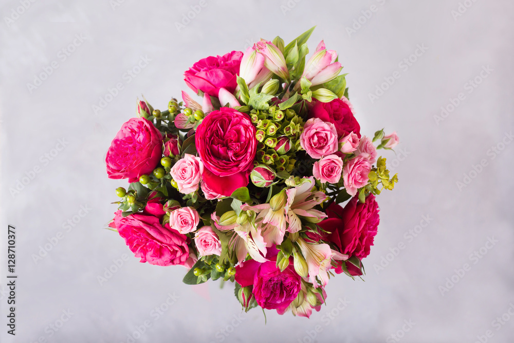 Bouquet of red, pink roses and pink peonies, alstroemeria. .  Still life with colorful flowers. Fresh roses.  Place for text. Flower concept. Fresh spring bouquet. Summer Background