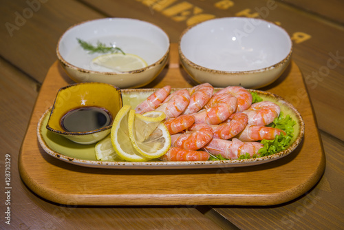 Mouth-watering shrimp on a plate lined with lettuce.